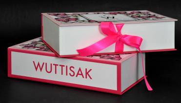 กล่องของขวัญติดริบบิ้นสีชมพูสีสวยหวาน ผูกเป็นโบว์ปิดฝากล่องได้แนบสนิท พิมพ์ชื่อ WUTTISAK ด้านข้าง